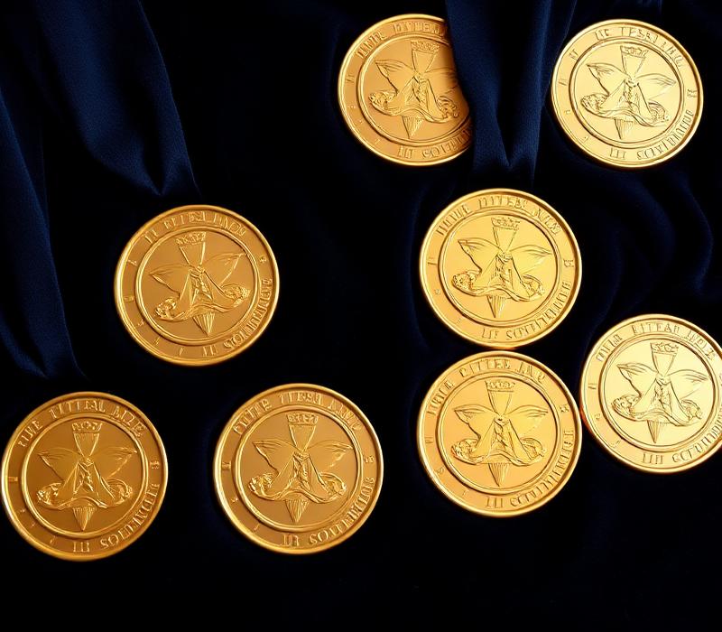 Commemorative gold medallions on navy velvet